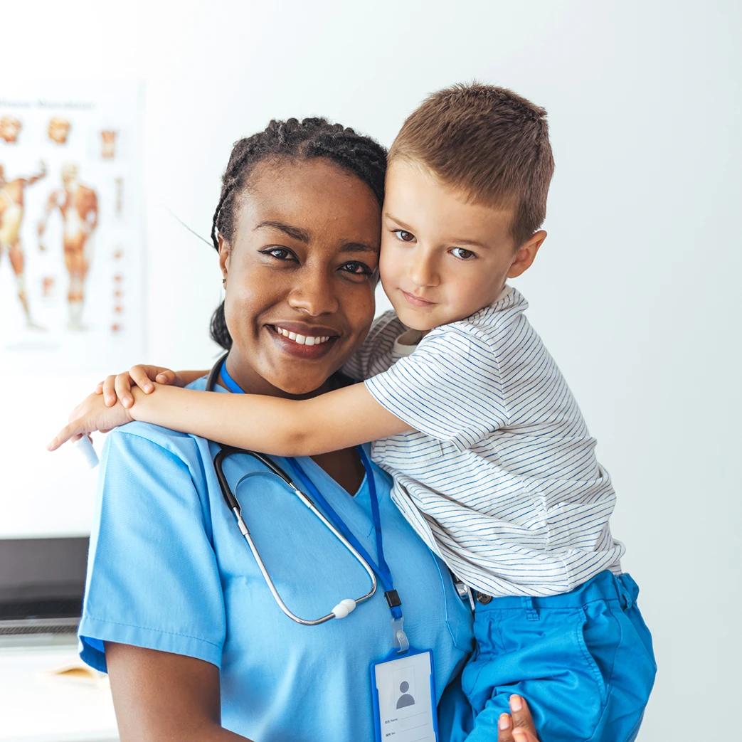 Nurse and boy hugging