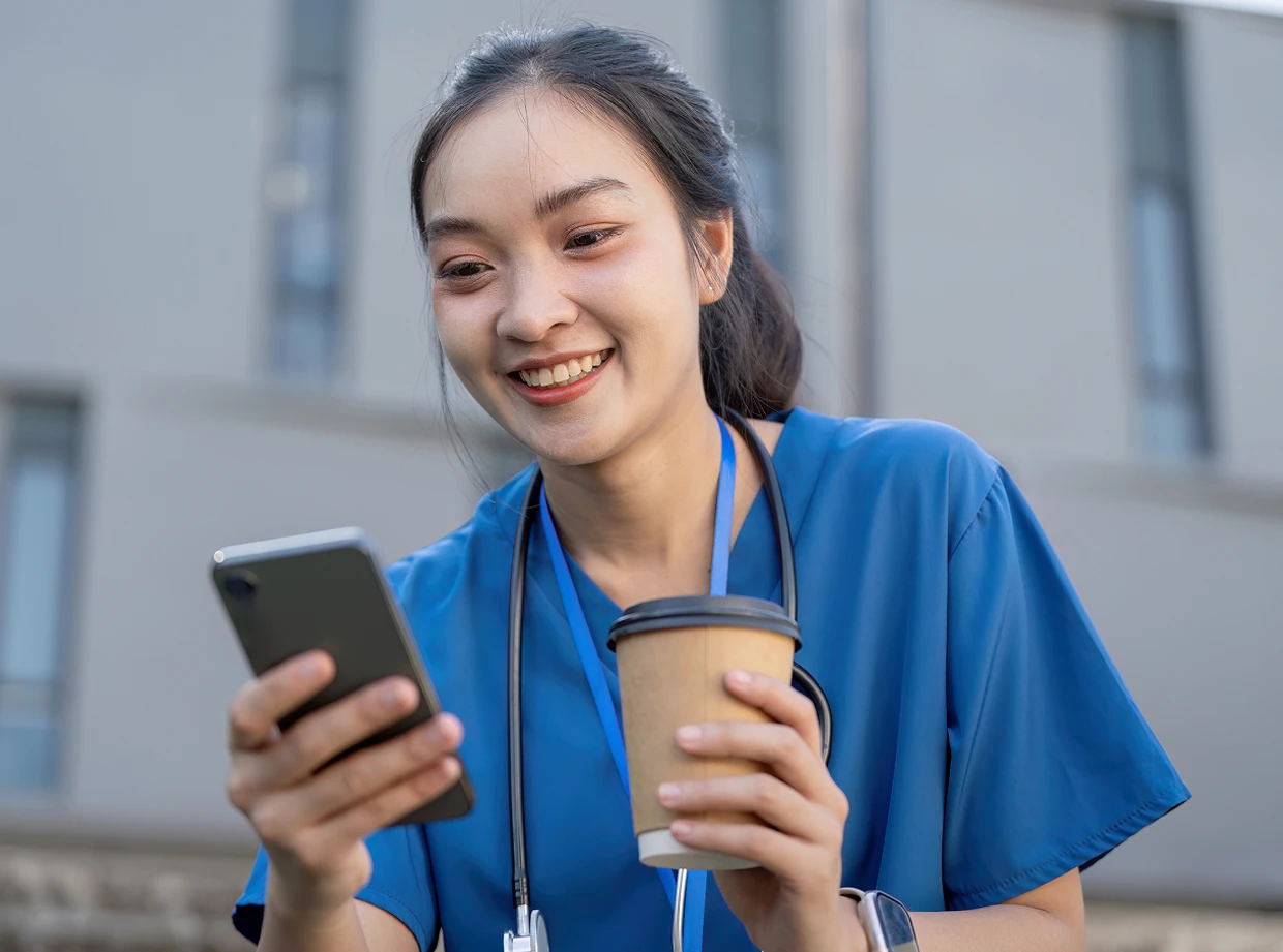 Nurse checking skills list on phone
