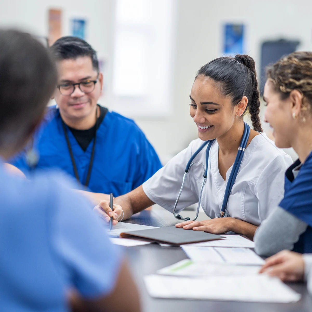 Nurse in hospital filling out papers