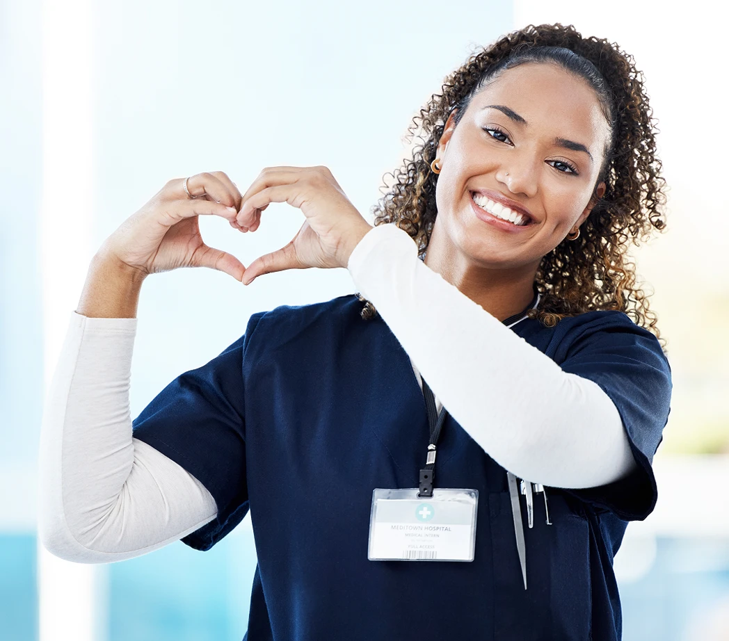 Nurse making heart with hand
