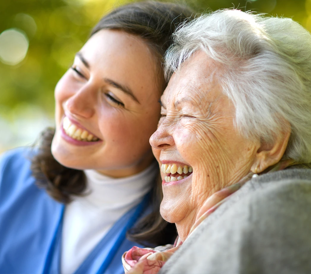 Young caregiver spending time with senior patient